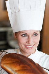 Confident female chef baking bread