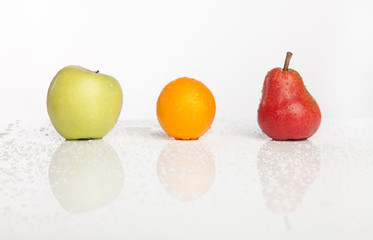 apple orange pear row with water drops
