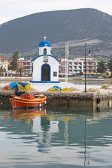 Fototapeta na wymiar Little Church and Boat in the Port