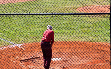 Groundskeeper Working Baseball Field