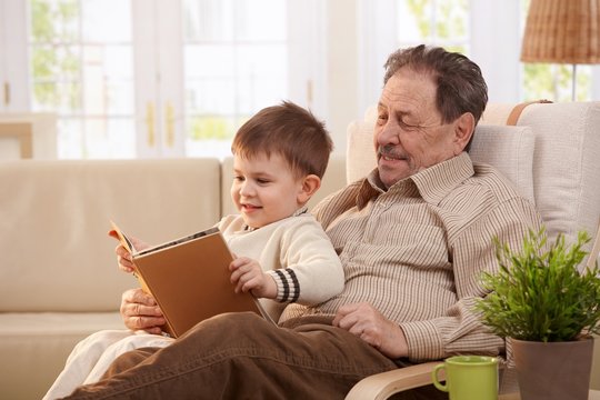 Grandfather reading tales to grandson