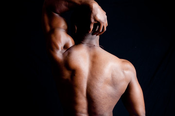 Strong man flexing his back muscles