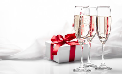 Gift decorated with bow, glass wine