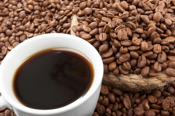 Cup with coffee, costing on coffee grain