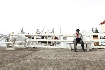 Man using laptop on the pier.