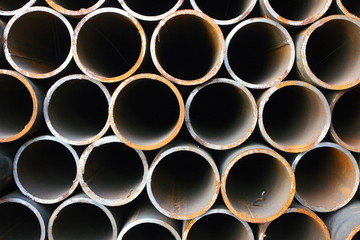 Close-up of steel high-pressure pipes bunch in warehouse