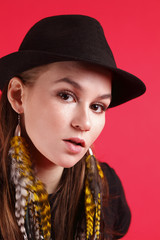 Young woman wearing a black fedora.