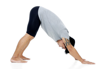 Portrait of a handsome young man in yoga stance