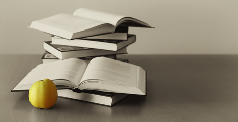 green apple and opened books