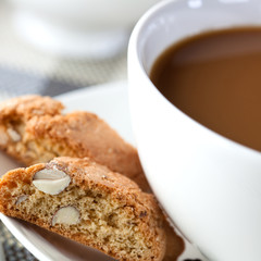 Cup of coffee with milk and cantuccini