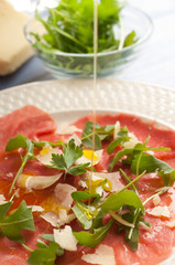 olive oil over rucola focus on olive oil on the rucola