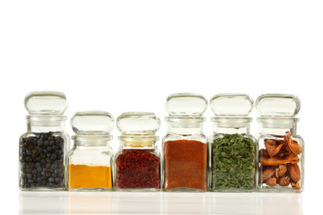 Glass jars with colorful herbs and spices.