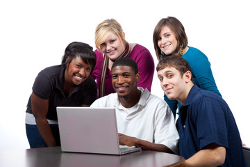 Multi-racial college students sitting around a computer