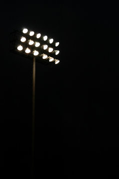 Stadium lights on a sports field at night with copy space