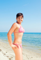 Fototapeta na wymiar young girl in bikini on beach
