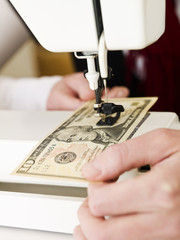 Sewing a dollar bank note