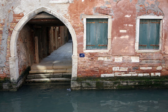 Ancient archway above backwater of Venice - Powered by Adobe
