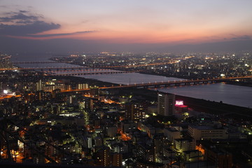 Illuminated Osaka City in Japan at sunset from high above