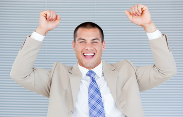 Successful businessman puniching the air