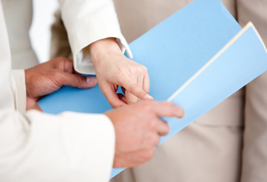 Close-up of a businesswoman pointing at a document