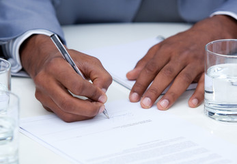 Close-up of ambitious business man signing a contract - obrazy, fototapety, plakaty