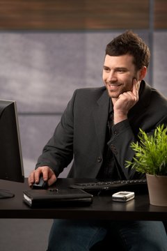 Smiling businessman with computer