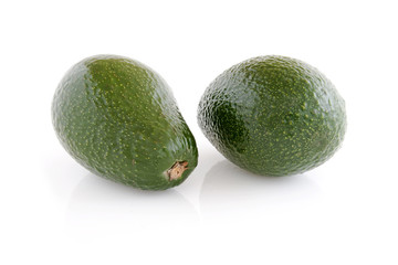 Two avocado fruits, isolated on white background.