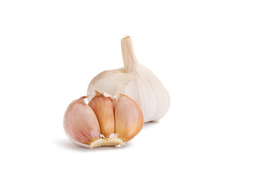 Clove and bulb of garlic on a white background