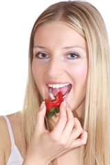 Caucasian woman eating strawberry