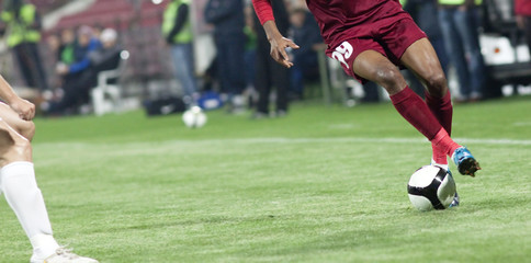 Soccer players running after the ball