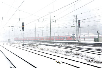 train in Wintertime on track in snow flurry