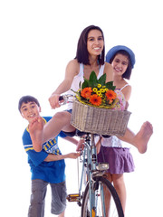children having fun pushing the girl on her bicycle