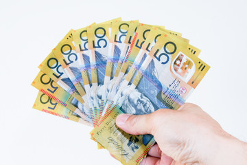 Australian fifty dollar notes in the hand.