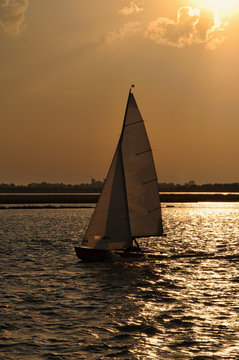 Silhouette of a sailing boat at sunset