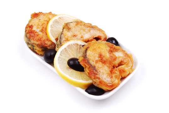 Fried fish with a lemon and olives