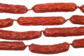 Background of tasty sausages on white
