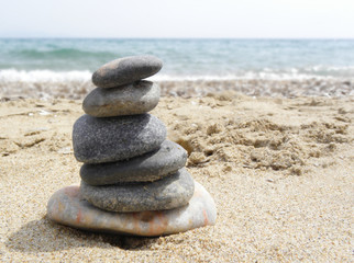 Fototapeta na wymiar cairn stones on the beach. beach at Mediterranean
