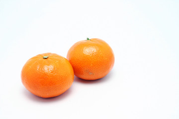 Two small  Mandarin oranges.