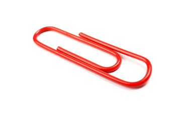 Red paper clip isolated on white background. Red paperclip cut out whited wite backgroung
