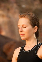 Fototapeta na wymiar A girl meditating outdoors
