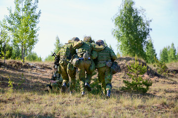 Two NATO Army soldiers escorted the wounded  soldier