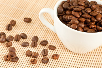 white cup of coffee and coffee beans
