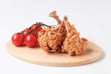 Chicken drumsticks coated with corn flakes