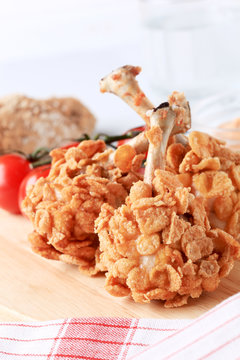 Chicken drumsticks coated with corn flakes
