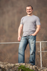 Young man full body portrait outdoors