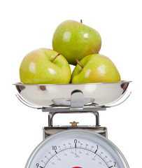 Fruit on a scale with a white background