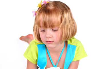 Cute little girl reading a magazine isolated over white