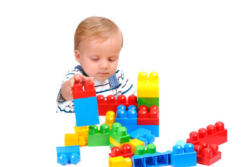 Cute little baby boy with colorful building blocks