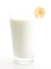 Glass of milk decorated with a slice of banana