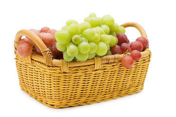 Wattled basket with grapes isolated on white